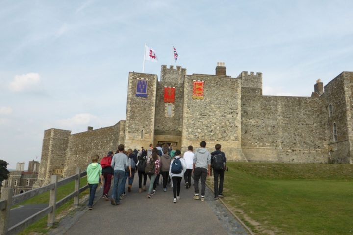 A group of students, seen from behind, walking up to the Great Tower of Dover Castle
